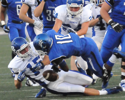 Ben Bruick (15) pulls the ball loose from Karlil Johnson (10) as help arrives from Bryce Denker (24). (Photo by Kevin Nagle)