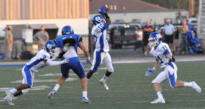 DeVonte Howard leaps to make a catch as teammates Brushawn Hunter (2) and Austin Vail (11) look to make blocks. (Photo by Kevin Nagle)