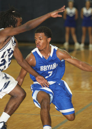 C.J. Rainey (3) tries to find room to drive against J.A. Fair's Corey Summons. (Photo by Rick Nation)