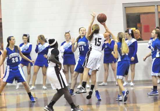 Annie Patton (21), Kailey Nagle (20), Anna Lowery (14) and Skylar Davis defend as Benton's Abby Clay (15) launches a shot. (Photo by Kevin Nagle)