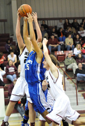 Bryant's Jaelynn Jones battles for a rebound between Benton's Westin Riddick and Andrew Norris. (Photo by Kevin Nagle)