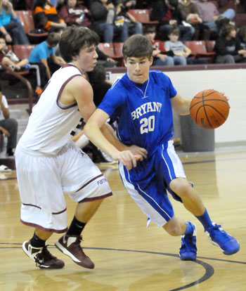 Bryant's Evan Lee tries to drive around a Benton defender. (Photo by Kevin Nagle)