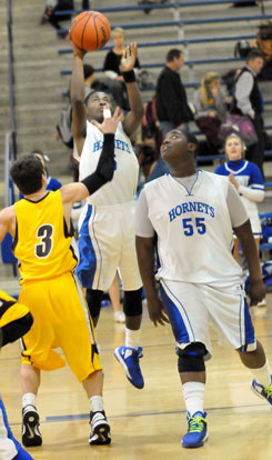 Kris Croom fires up a short jumper over Lake Hamilton's Dallas Baldwin (3) as teammate Cameron Murray (55) sets up to go after the rebound. (Photo by Kevin Nagle)