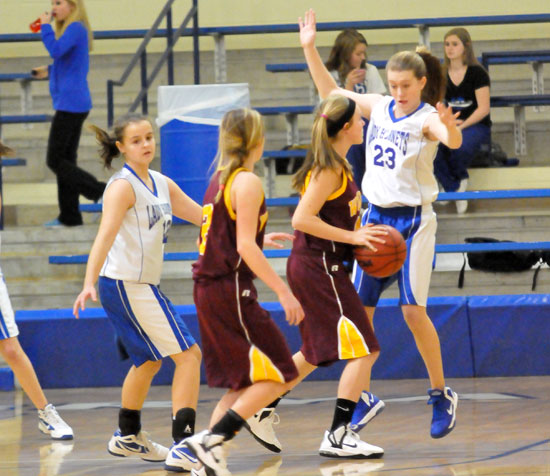 Bryant Blue's Kendal Rogers (23) and Sarah Kennedy (12) defend against the Lake Hamilton Junior Lady Wolves. (Photo by Kevin Nagle)