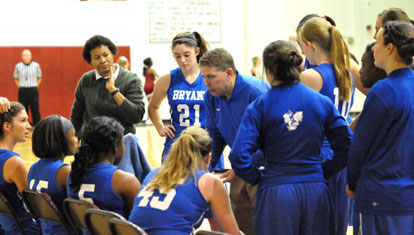 Bryant head coach Brad Matthews and assistant Trina Williams visit the Lady Hornets during a timeout. (Photo by Kevin Nagle)