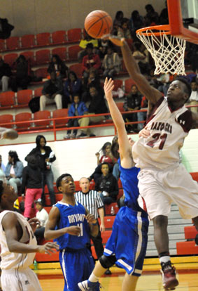 Texarkana's LaDonta Cursh (21) blocks a shot by Skyler McKissock as Bryant's Strodney Davis trails the play. (Photo by Kevin Nagle)