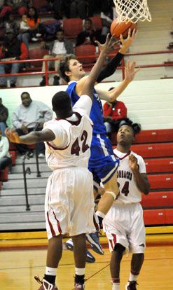 Luke Rayburn scoops up a shot after penetrating the Texarkana defense. (Photo by Kevin Nagle)