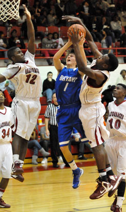 Tyler Simmons (1) goes to the hole in a crowd. (Photo by Kevin Nagle)