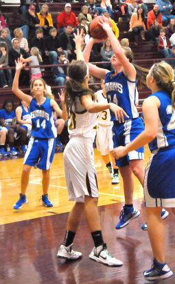 Britney Sahlmann takes a shot as Anna Lowery and Anna Turpin get in position for a rebound. (Photo by Kevin Nagle)