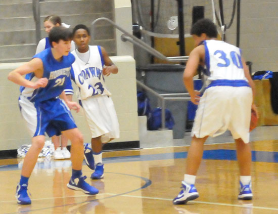 Hunter Handly, left, guards against a Conway White ballhandler. (Photo by Kevin Nagle)