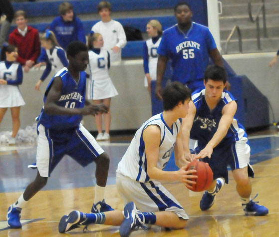 Bryant's Clay ingold tried to tie up a Conway White player as Kevin Hunt (10) comes in to help. (Photo by Kevin Nagle)