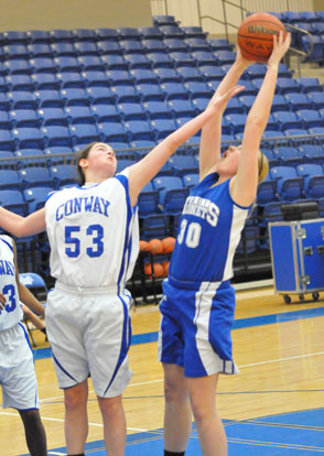 Bryant's Rachel Miller reaches for a rebound over Conway White's Hailey Estes. (Photo by Kevin Nagle)