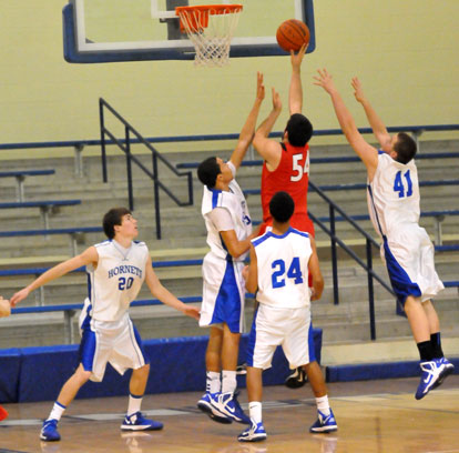 A Cabot South player goes up for a shot as Bryant's Evan Lee (20), Jaelynn Jones, Trey Harris (24) and Dagen Cardin (41) try to defend. (Photo by Kevin Nagle)