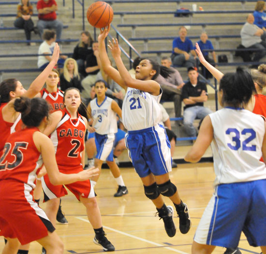 Destiny Martin (21) leans into a jump shot as teammates Jadyn Lewis (3) and Kennedy Harris (32) get into position. (Photo by Kevin Nagle)