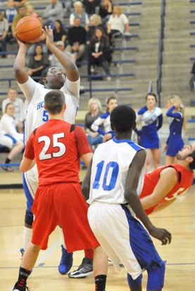 Cameron Murray goes up for a shot in front of teammate Kevin Hunt as a Cabot defender tries to take a charge. (Photo by Kevin Nagle)