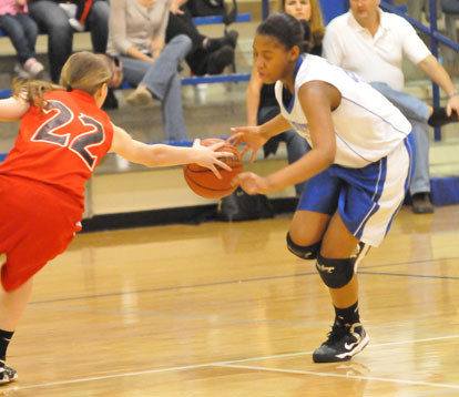 Bryant's Deja Rayford (right) tries to dribble around a Cabot South defender. (Photo by Kevin Nagle)