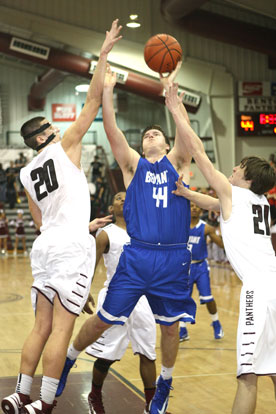 Bryant's Zach Cambron (44) shoots between Benton's Josh Bowling (20) and Blake Bowlin (21). (Photo by Rick Nation)