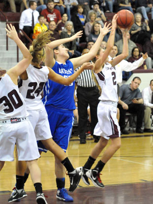 Bryant's Whitney Meyer contends with three Benton players for a rebound. (Photo by Kevin Nagle)