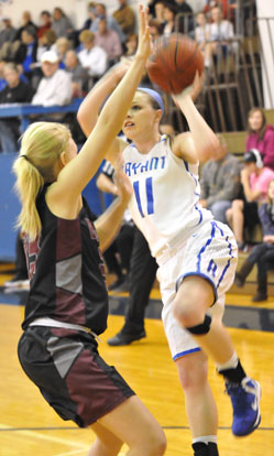 Logan Davis (11) attempts a jumper over Benton's Carmen King. (Photo by Kevin Nagle)