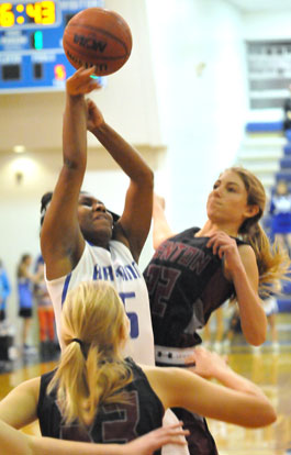 Bryant's Dezerea Duckworth tries to get a shot away in traffic between Benton's Braxton Chumley (22) and Korie Parker (12). (Photo by Kevin Nagle)