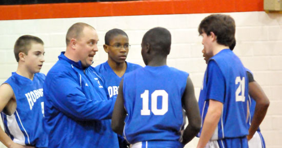 Bryant Blue coach Derek McGrew instructs his crew during a timeout in Monday night's game at Malvern. (PHoto by Kevin Nagle)