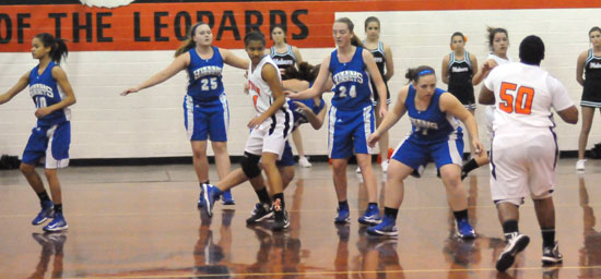 From left, Anne Marie Kieth, Anna Turpin (25), Britney Sahlmann (24) and Carolyn Reeves (31) defend against the Malvern Lady Leopard Cubs Monday night. (Photo by Kevin Nagle)