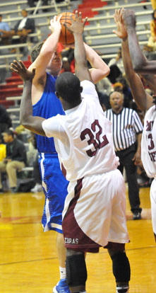 Zach Cambron tries to get a shot over Pine Bluff's Cameron Jackson. (Photo by Kevin Nagle)