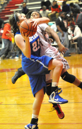 Courtney Davidson gets fouled as she drives to the basket. (Photo by Kevin Nagle)