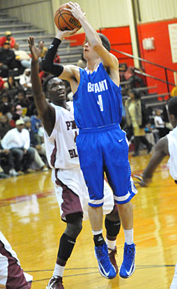 Tyler Simmons pulls up for a shot in front of Pine Bluff's Tyrone Payne. (Photo by Kevin Nagle)