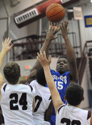 John Winston fires up a shot over a cluster of Benton defenders. (Photo by Kevin Nagle)