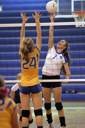 Mercedes Dillard (7) gets a hit over the net. (Photo by Rick Nation)