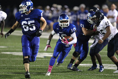 Devonte Howard (10) heads upfield off a block by Kurt Calley (61) with Jacob Ward (65) running interference. (Photo by Rick Nation)