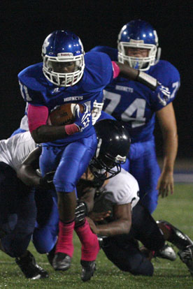 Sevonte Turner (31) heads upfield off a block by Caleb Chaffin (74). (Photo by Rick Nation)