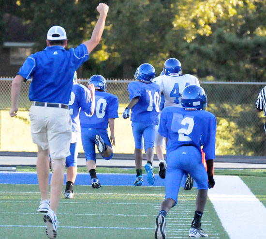 Bryant White head coach Brad Smothermon celebrates the long touchdown run by Grant Botti that put his team ahead late in the fourth quarter. (Photo by Kevin Nagle)