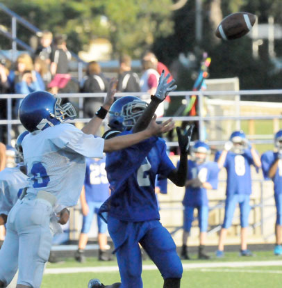 Jesse Windemaker, left, and Randy Thomas, right, go after a Bryant Blue pass. (Photo by Kevin Nagle)