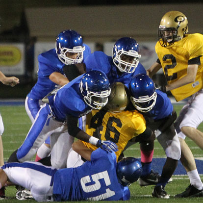 Bryant defenders including Madre Dixon (51) stack up Central's Malik Onwumere. (Photo by Rick Nation)