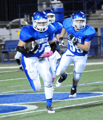 Hayden Knowles heads up field after making an interception. Teammate Chase Fox (89) looks for someone to block. (Photo by Kevin Nagle)