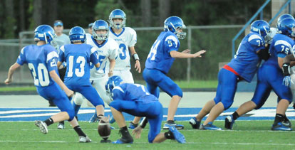 Luke Welch (20) attempts an extra point. (Photo by Kevin Nagle)