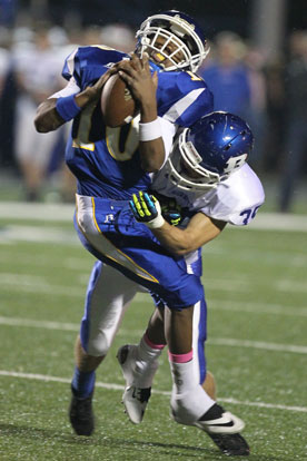 Jake Johnson drives through a tackle against Sheridan's D'Anthony Whitaker. (Photo by Rick Nation)