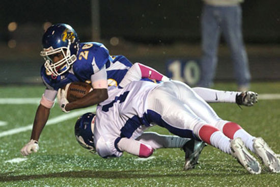 Drew Tipton (1) tackles Sheridan's McKenzie Jones for a loss. (Photo by Rick Nation)