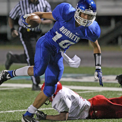 Austin Kelly slips past a Cabot South defender on his way to the end zone. (Photo by Rick Nation)