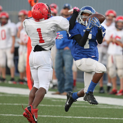 Bryant White's Aaron Griffin (7) grabs a pass despite the efforts of Cabot South's Marc Magwood (1). (Photo by Rick Nation)