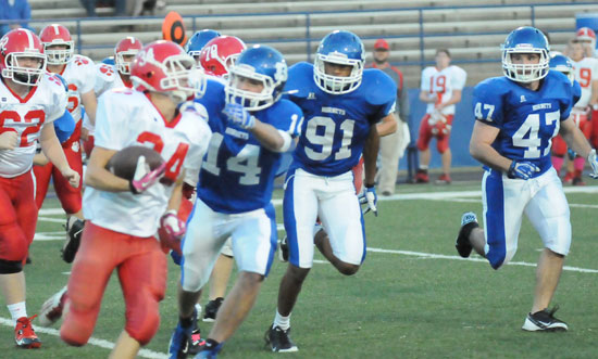 A trio of Bryant defenders including Kameron Guillory (91) and Peyton Robertson (47) chase down a Cabot runner. (Photo by Kevin Nagle)