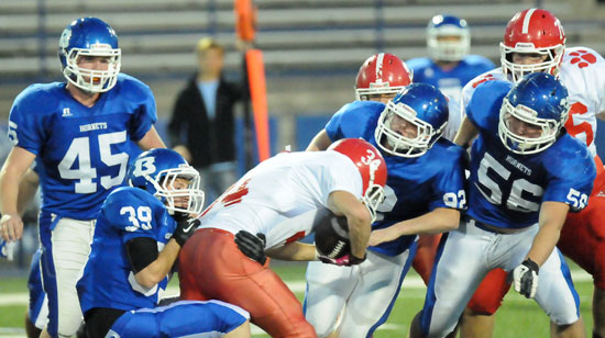 Brice Hardin (39) and Austin Blacklaw (92) grab a Cabot running back as help arrives from Drew Allen (56) and Walker Brown (45). (Photo by Kevin Nagle)