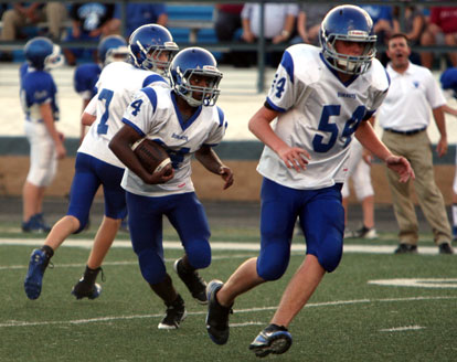 Diante Woodson cuts upfield while teammate Cole Campbell (54) looks for someone to block. (Photo by Rick Nation)