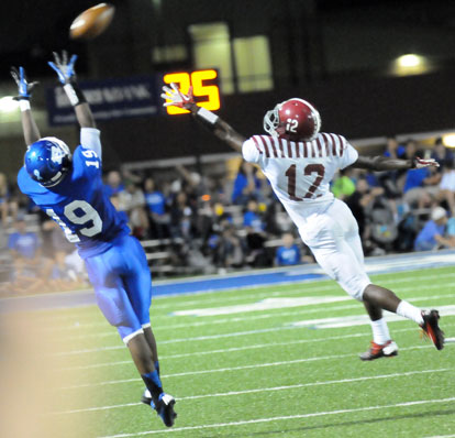 Bryant's Kylon Boyle (19) reaches high for a pass beyond the reach of Pine Bluff's Jayshon Williams (12). (Photo by Kevin Nagle)