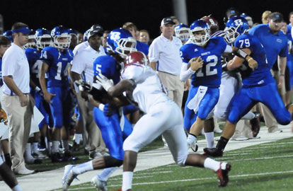 Bryant quarterback Brandan Warner (12) tightropes the sideline with help from Darian Jarrett (5) and Jordan Jones (79). (Photo by Kevin Nagle)