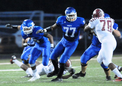 Cameron Davis (77) looks to help make room for teammate Brendan Young. (Photo by Kevin Nagle)