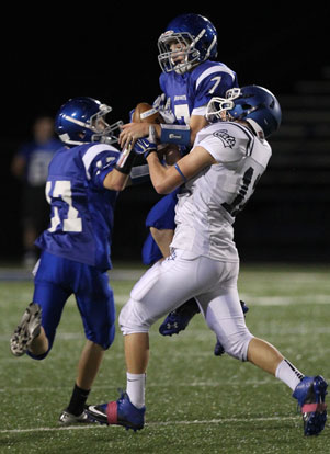 Cameron Vail (7) latches onto a Conway White pass intended for Logan White (12) with Matt Sandidge (17) helping out on the play. (Photo by Rick Nation)