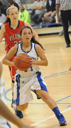 Macey Jaramillo (11) looks for an open teammate as Vilonia's Skylar Lee shadows her. (Photo by Kevin Nagle)